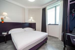 Letto o letti in una camera di Hotel Majorana