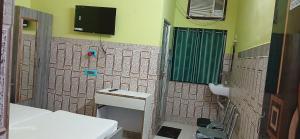 a bathroom with a toilet and a sink and a tv at Hotel Bhagwat Palace in Gaya