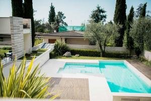 a swimming pool in the backyard of a house at Casa Chiara in Gardone Riviera