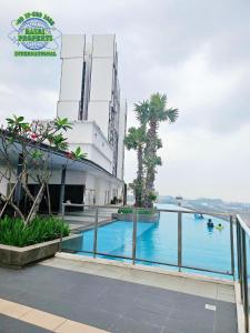 a swimming pool in front of a building at I-City I-Residence BestStudio POLOS BASRI PROPERTI in Shah Alam +7 photos