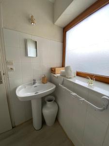 a bathroom with a sink and a mirror at maison 5 pers Le Penty d 'Argol Crozon animaux acceptés in Argol