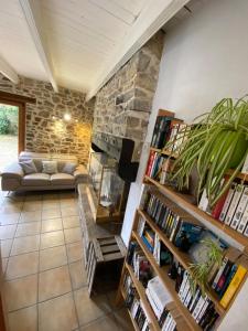 a living room with a stone fireplace and a couch at maison 5 pers Le Penty d 'Argol Crozon animaux acceptés in Argol
