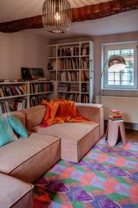 a living room with a couch and a rug at Sfeervolle B&B in de Voerstreek Lo-Ghis - met Zwembad in Voeren