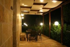 a patio with a table and chairs at night at La Trullesa Holiday in Alberobello