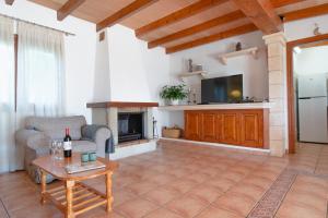 a living room with a couch a table and a fireplace at Es Ravellar - Campos in Islas Baleares