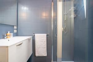 a bathroom with a shower with a glass door at Terrazza incanto, con terrazza e garage in Desenzano del Garda +17 photos