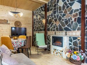 a living room with a fireplace and a table at Mestia Alpine Cottage in Mestia