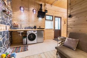 a kitchen with a washing machine in a room at Mestia Alpine Cottage in Mestia