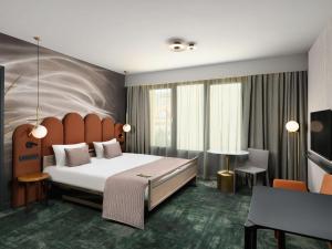 A bed or beds in a room at Mercure Debrecen