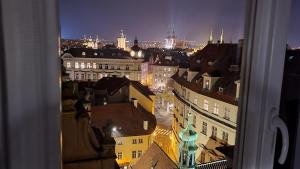 a view of a city at night from a window at Luxury Apt - View of the Center of Prague in Prague