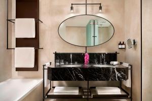 a bathroom with two sinks and a mirror at Tivoli Portopiccolo Sistiana Wellness Resort & Spa in Sistiana