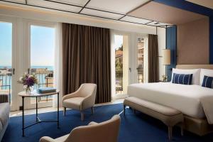a hotel room with a bed and a balcony at Tivoli Portopiccolo Sistiana Wellness Resort & Spa in Sistiana