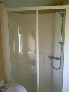 a bathroom with a shower and a sink at Highfields Rio 6 berth blow heated in Skegness +13 photos