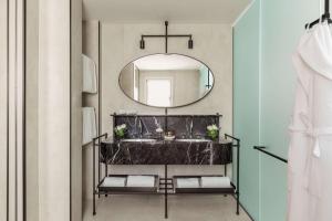 a bathroom with a sink and a mirror at Tivoli Portopiccolo Sistiana Wellness Resort & Spa in Sistiana