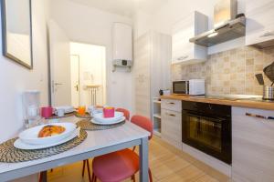 a kitchen with a table with plates of food on it at Fleming Ospedale 300Mt Wifi Aria condizionata Free parking in Parma