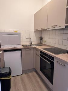 a kitchen with white appliances and a sink at Ferienwohnung Wilma Hinterzarten in Hinterzarten
