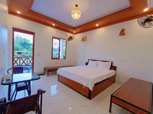 a bedroom with a bed and a table at New Day Homestay in Ninh Binh +78 photos