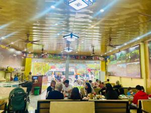 a group of people sitting at tables in a restaurant at New Day Homestay in Ninh Binh