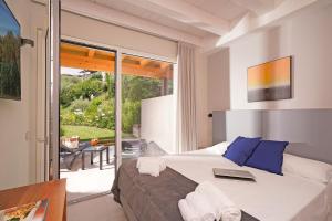 a bedroom with a bed with a laptop on it at Lamasu RioVerde - Lago di Garda in San Felice del Benaco