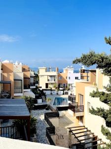 a view of a building with a swimming pool at Pepper House with pool in Argaka