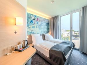 Postel nebo postele na pokoji v ubytování B&B HOTEL Offenburg-Hbf