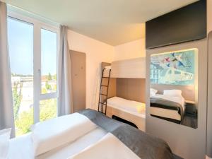 Postel nebo postele na pokoji v ubytování B&B HOTEL Offenburg-Hbf