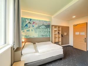 Postel nebo postele na pokoji v ubytování B&B HOTEL Offenburg-Hbf