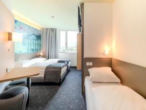Postel nebo postele na pokoji v ubytování B&B HOTEL Offenburg-Hbf