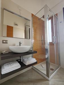 a bathroom with a sink and a glass shower at Villa Orsola in Villaputzu +100 photos