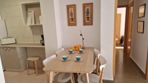 a kitchen and a table with cups and oranges on it at Gandia Grau 5 in Gandía