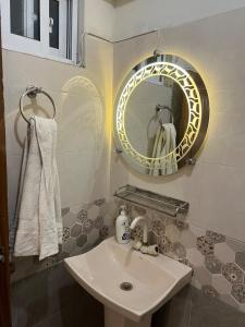 a bathroom with a sink and a mirror at Two BR l DHA Phase 5 l Near Seaview l First Floor in Karachi