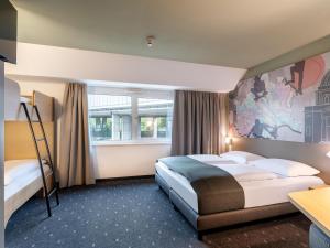 Postel nebo postele na pokoji v ubytování B&B HOTEL Wien-St-Marx