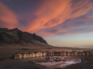 eine Gruppe von Häusern vor einem Berg in der Unterkunft Hótel Jökulsárlón - Glacier Lagoon Hotel in Gerdi