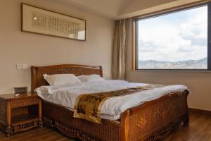 Postel nebo postele na pokoji v ubytování Zhangjiajie Chunshanzhu Bed and Breakfast