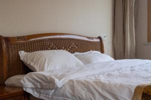 Postel nebo postele na pokoji v ubytování Zhangjiajie Chunshanzhu Bed and Breakfast