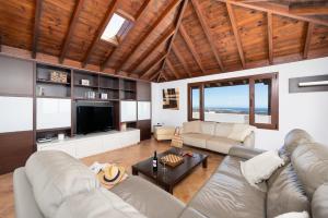 a living room with a couch and a table at Villa Asomada in La Asomada