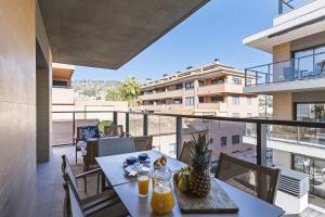 a dining table on a balcony with a view of a building at Nova Essential in Jávea