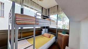 a bedroom with two bunk beds and a window at For Sea Lovers in Cubelles