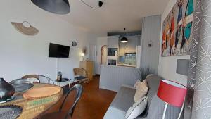 a living room with a table and a dining room at For Sea Lovers in Cubelles