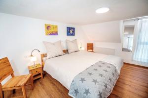 a bedroom with a bed and a wooden floor at Ferienhaus Sternschnuppe in Oberwesel