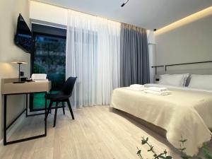 a bedroom with a bed and a desk with a computer at ICON Urban Living in Thessaloniki