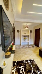 a living room with a large flat screen tv at Horus pyramids view in Cairo