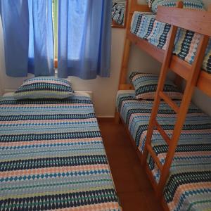 two twin bunk beds in a room with a window at Costa Arenal 81 in Arenal d'en Castell +14 photos