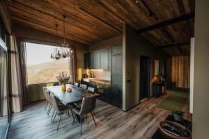 a kitchen and dining room with a table and chairs at Black Diamond Villa in Mosfellsbær