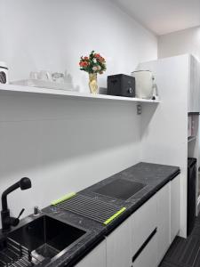 a kitchen with a sink and a counter top at Amber Lake C in Auckland