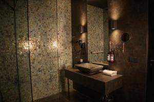 a bathroom with a sink and a glass shower at Manzo's Suites in Zaandam +12 photos