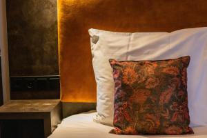 a pillow sitting on top of a bed at Manzo's Suites in Zaandam