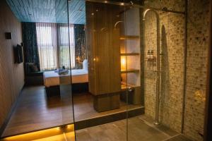 a bathroom with a shower and a bed in a room at Manzo's Suites in Zaandam +19 photos