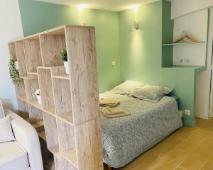 a room with a bed and a wooden book shelf at Studio en rez-de-maison in Le Muy