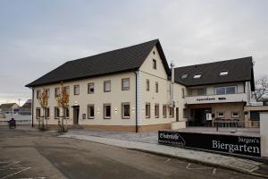 a large white building on the side of a street at S'bahnhöfle Apartments in Ringsheim